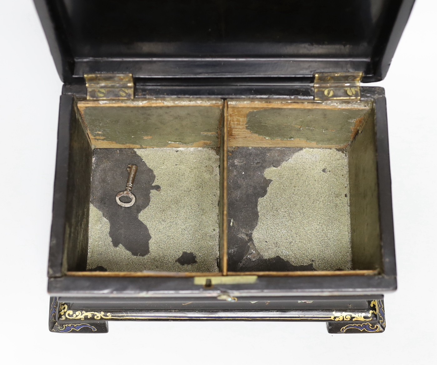 A Victorian painted and mother of pearl inlaid papier mache tea caddy. 23cm wide